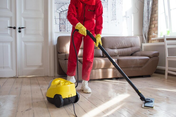 cleaner-red-uniform-cleans-floor-with-help-steam-coming-out-nozzle_340855-3200